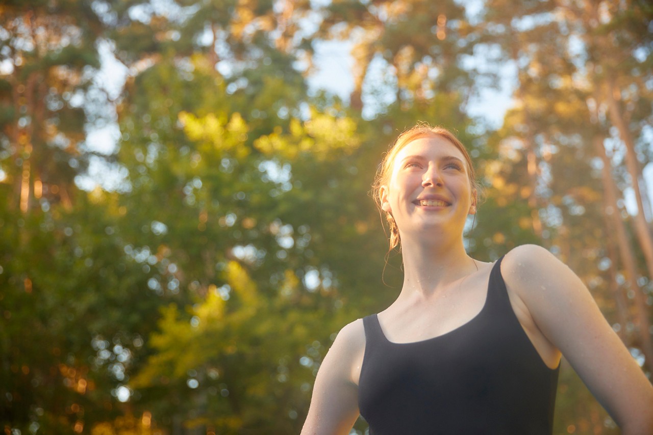 Woman resting on the edge of an outdoor hot tub